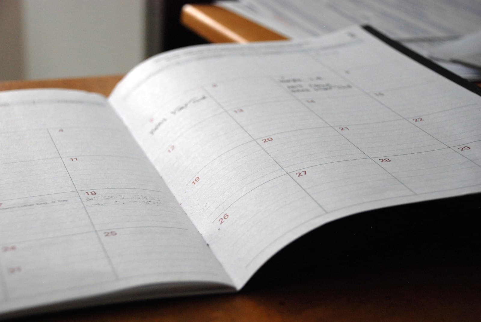 Open monthly planner on a wooden desk