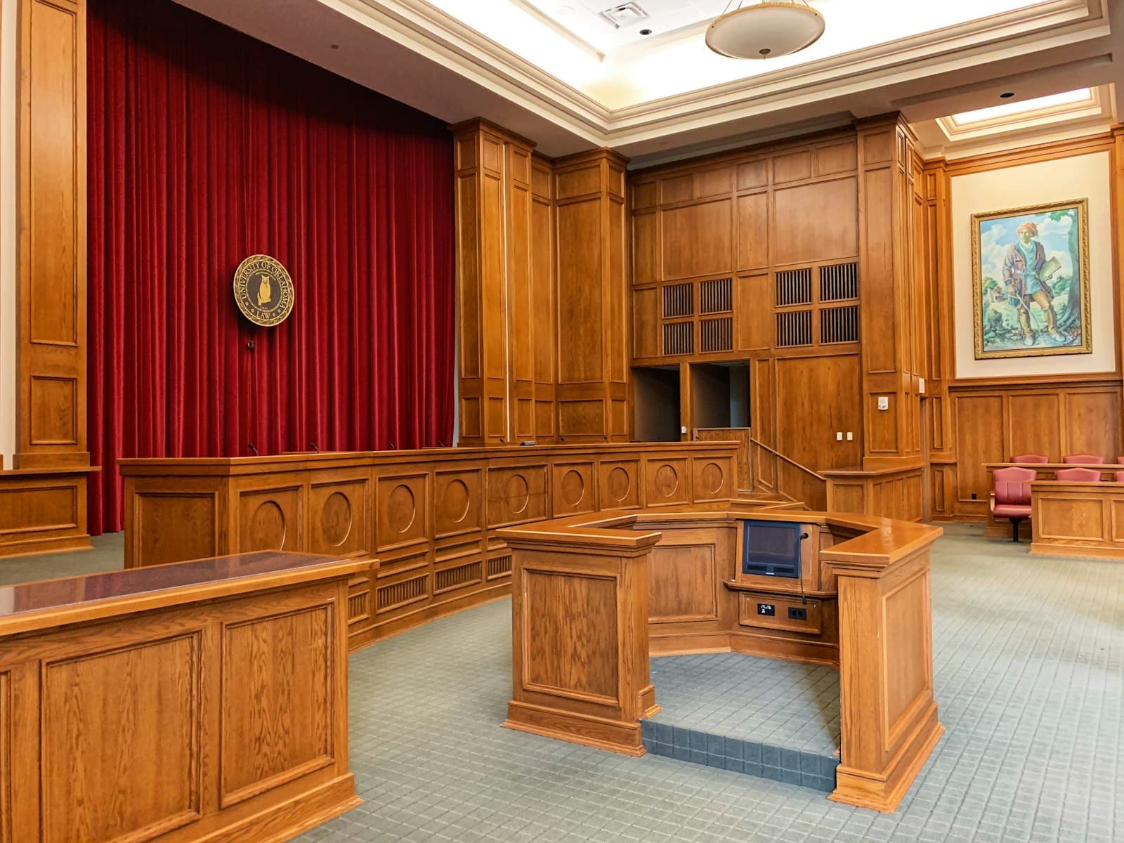 Empty wood-paneled courtroom seen from the gallery