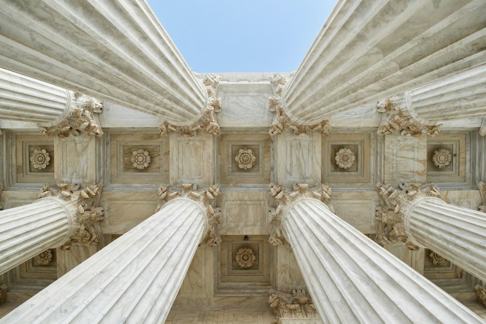Gray stone courthouse columns seen from below